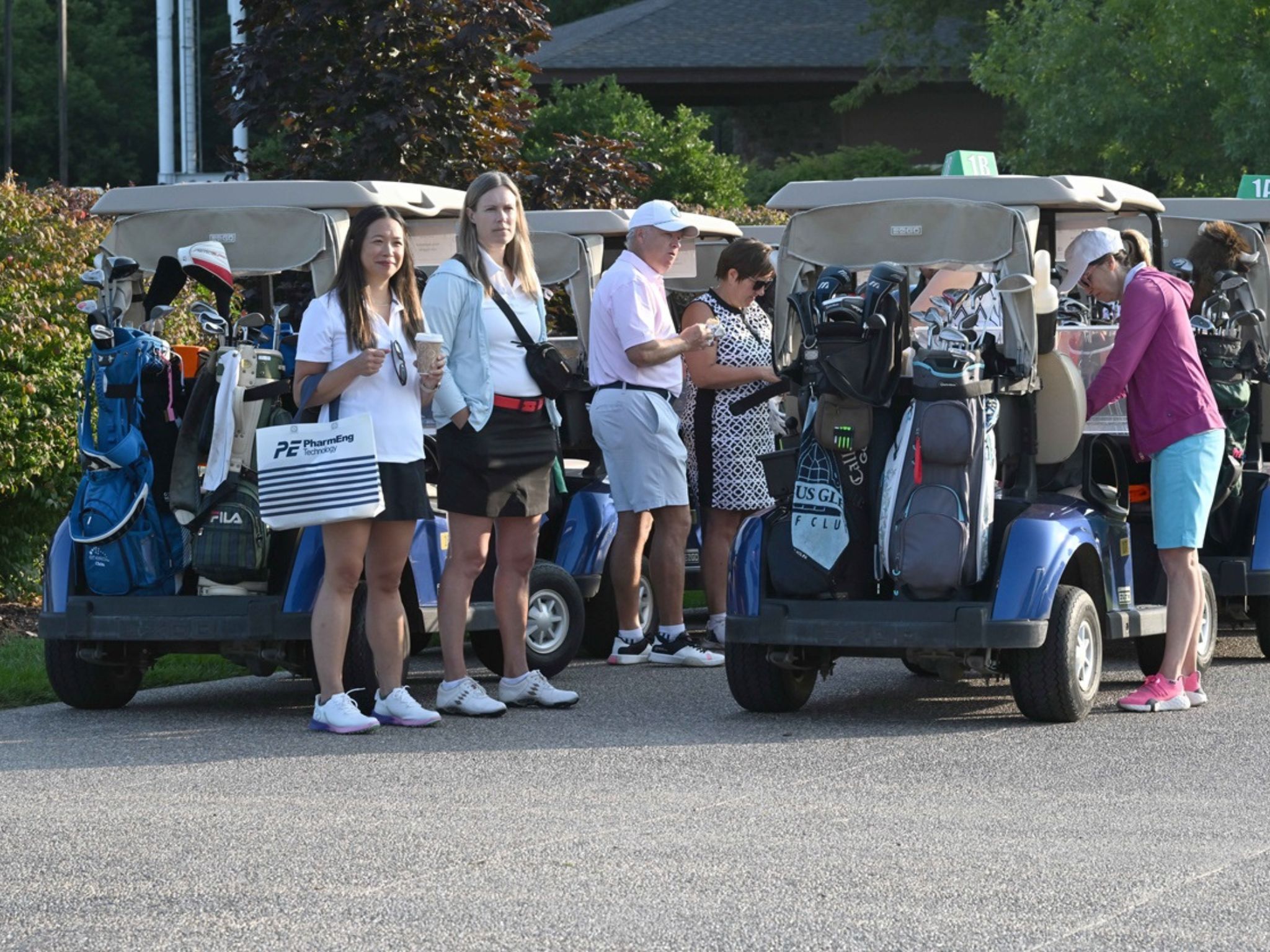 Group of golfers by golf carts