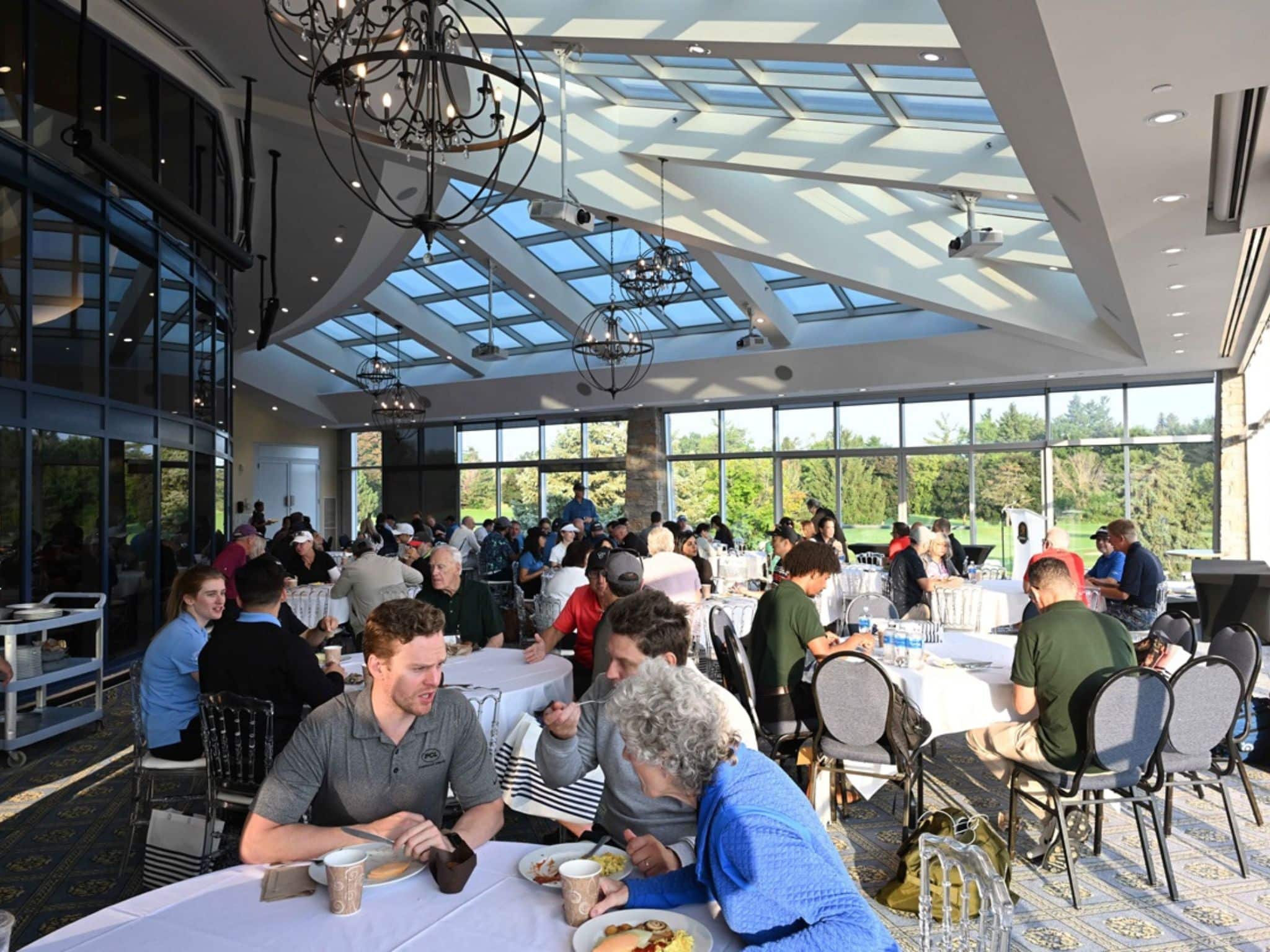 Crowded dining area with large windows