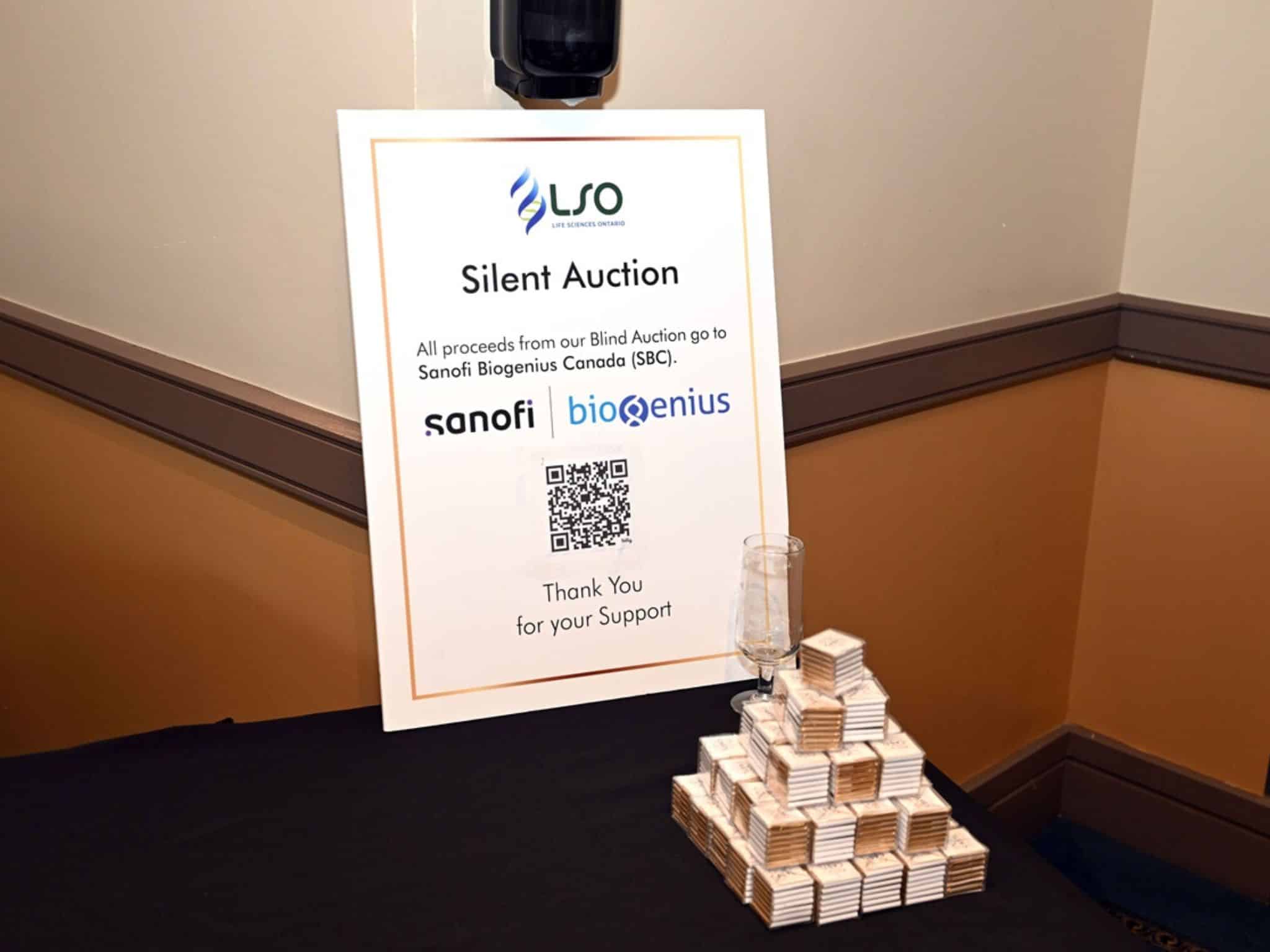 Silent auction sign with stacked items