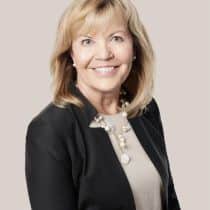Smiling woman in professional attire.