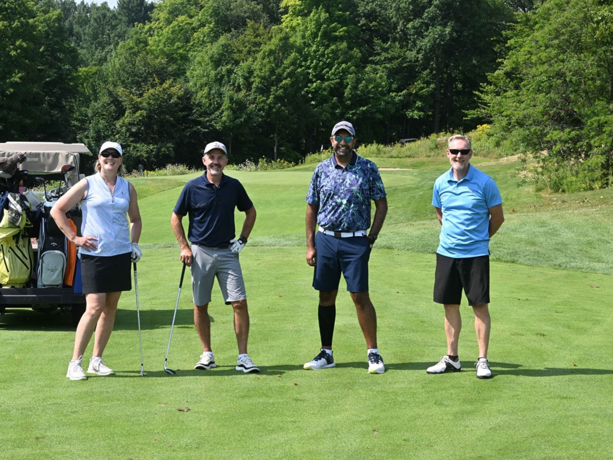 Four golfers on a green course