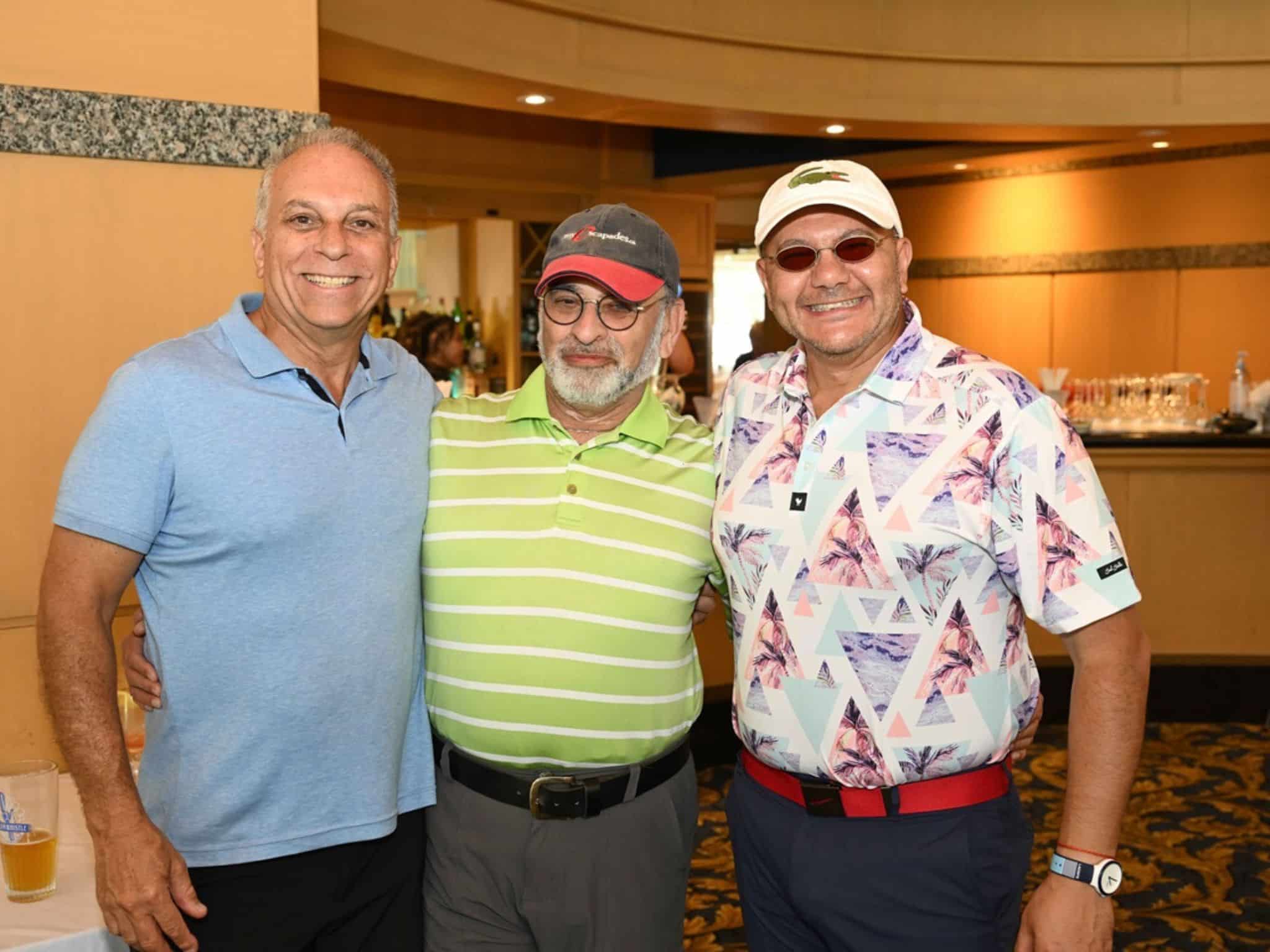 Three men smiling together indoors