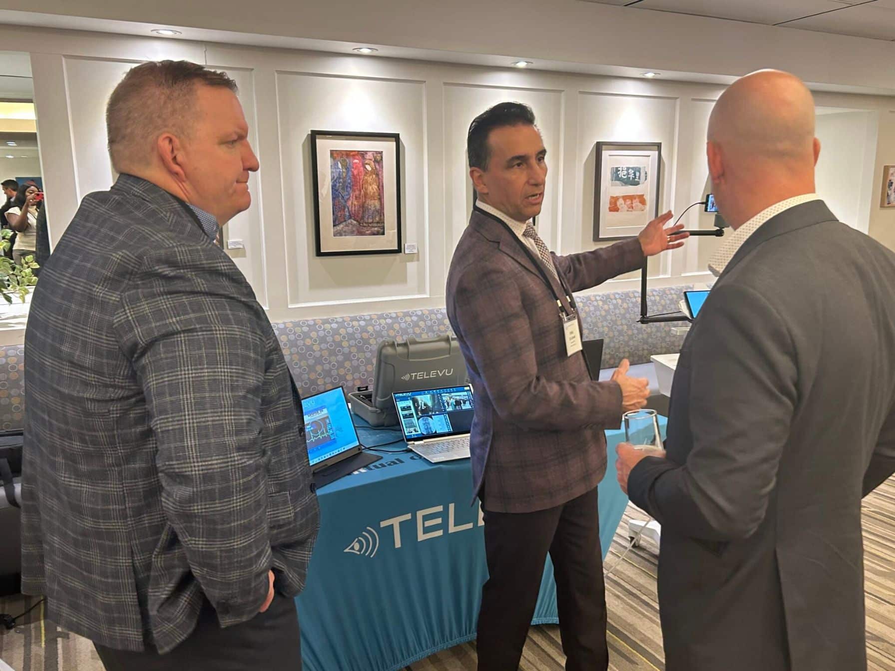 Businessmen discussing technology at event