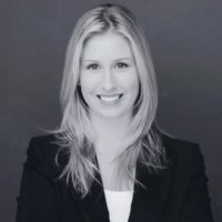 Smiling woman in professional attire.
