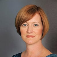 Woman with short, reddish-brown hair