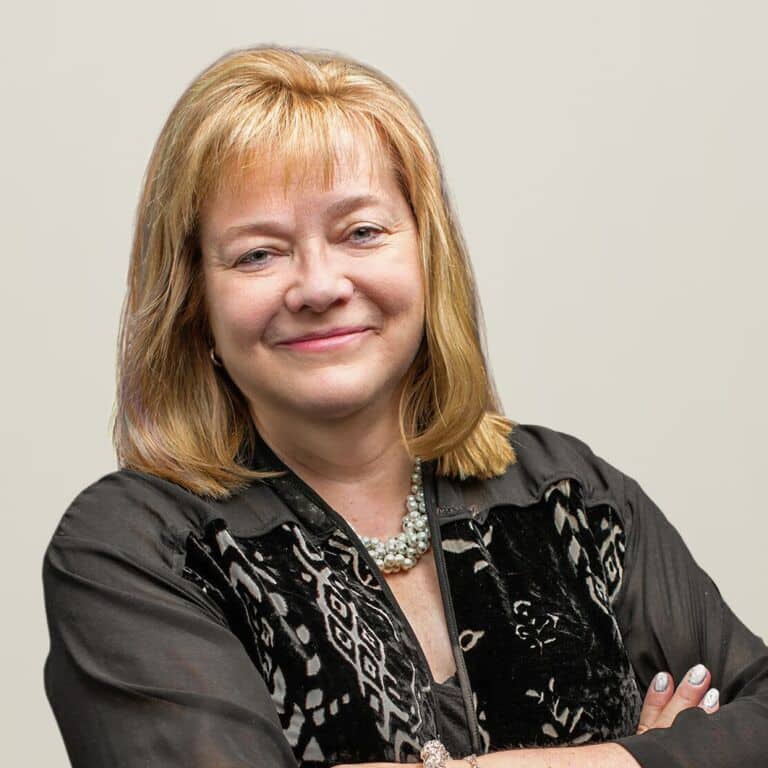 Smiling woman with crossed arms