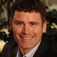 Smiling man in professional attire.