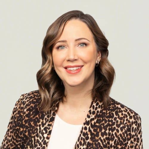 Woman in leopard print blazer smiling