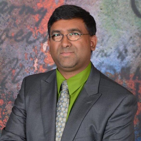 Man in suit with green shirt