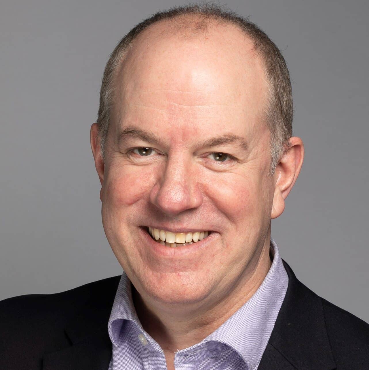 Smiling man in professional attire.