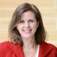 Smiling woman in red jacket.